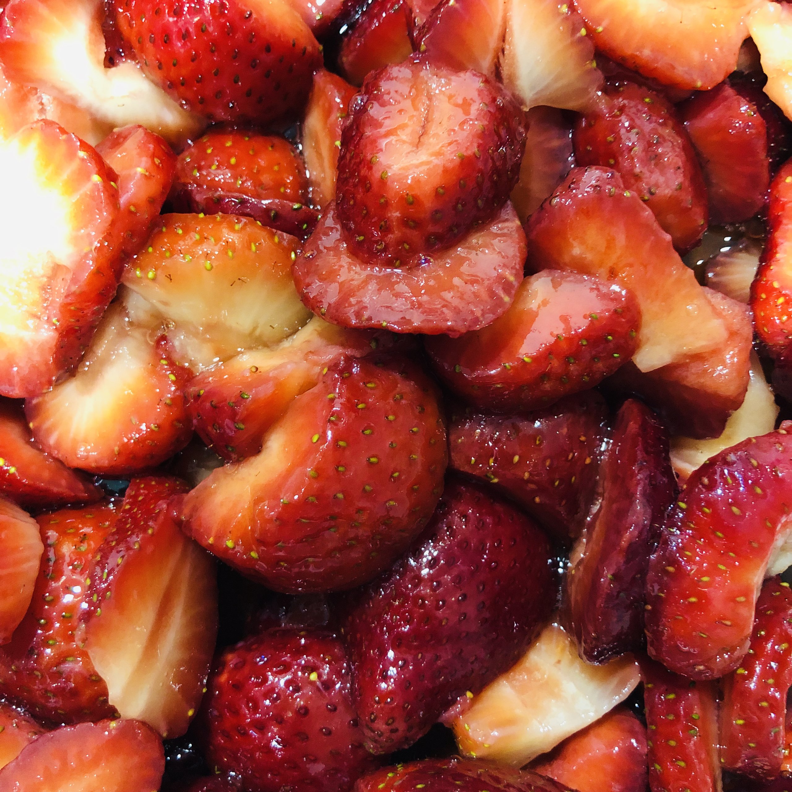 Glossy macerated strawberries, close up